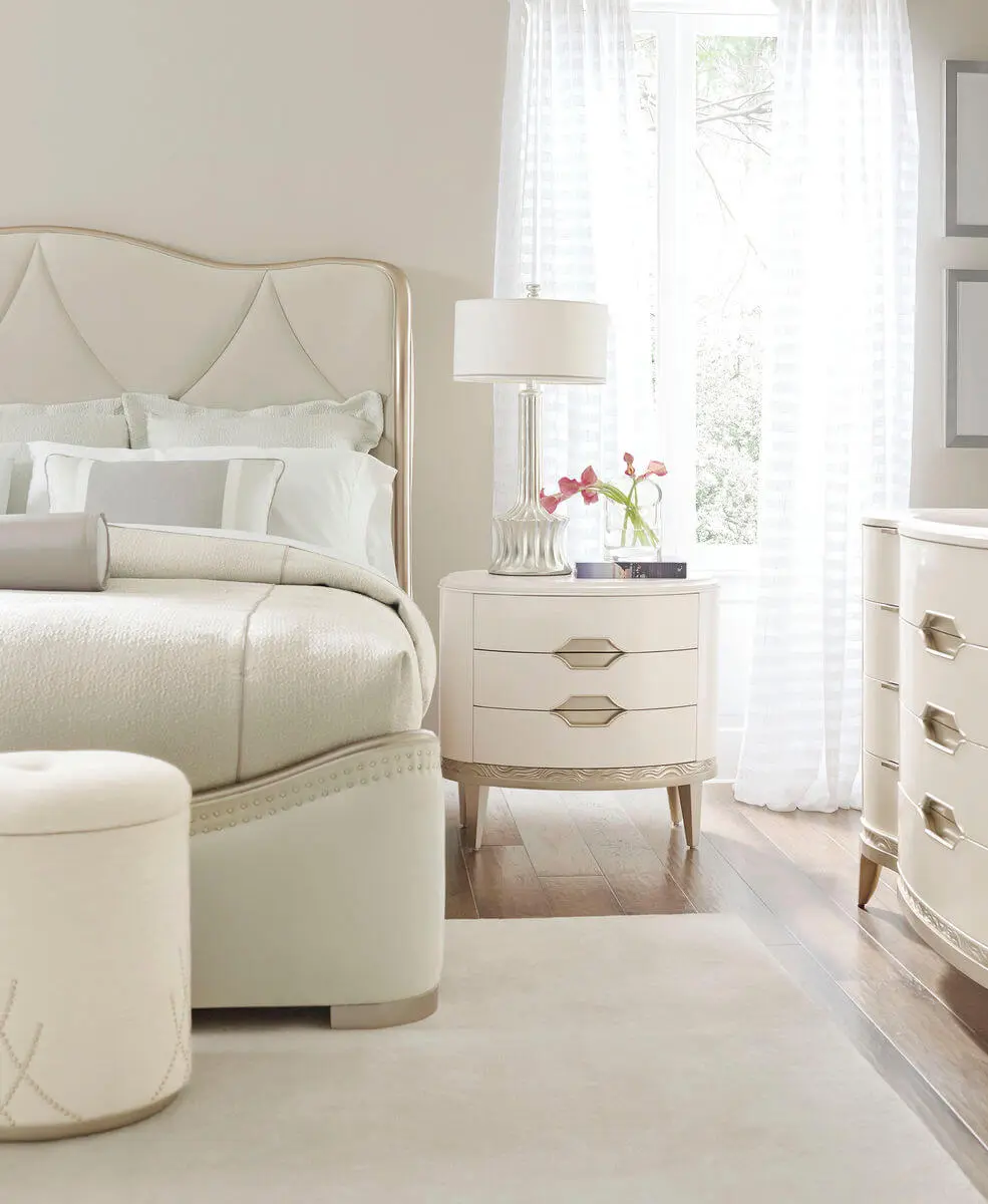 cream sleigh bed staged in neutral beige staged bedroom