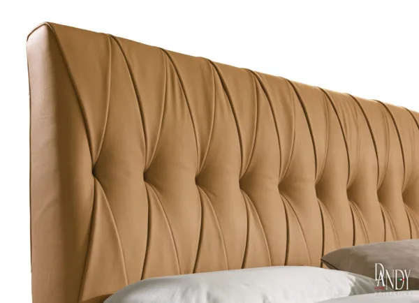 closeup of rust marlon leather bed with cross tufting in a contemporary room setting