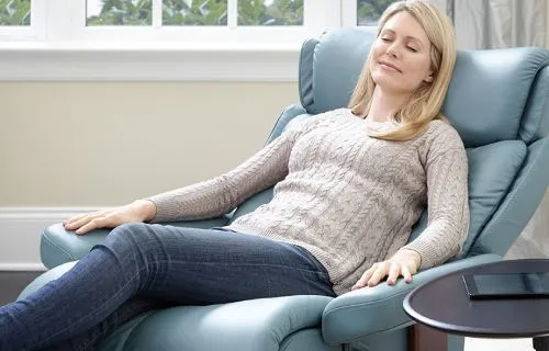 Relaxed looking woman sitting on recliner chair