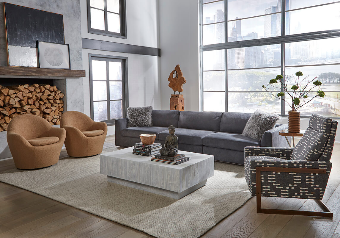 ED.Siena_3pcSofa_AxelIndiaInk_FelizSwivel_DollyCamel_IslaReclinerClosed_PierceAsh_Lifestyle Siena a contemporary charcoal sectional in modern home with neutral tone decor by American Leather