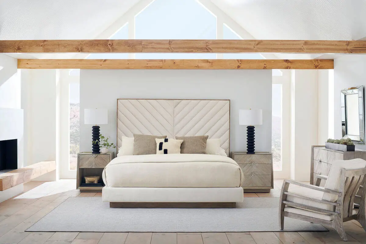 beige bed wood trim with chevron design headboard staged photo in white well lit room