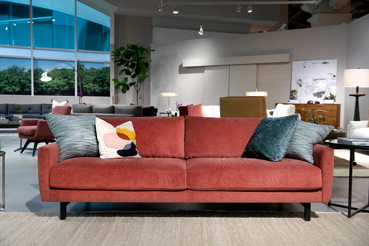 ED.Carmet_Sofa_PiperSangria peach two seat sofa with blue pillows
