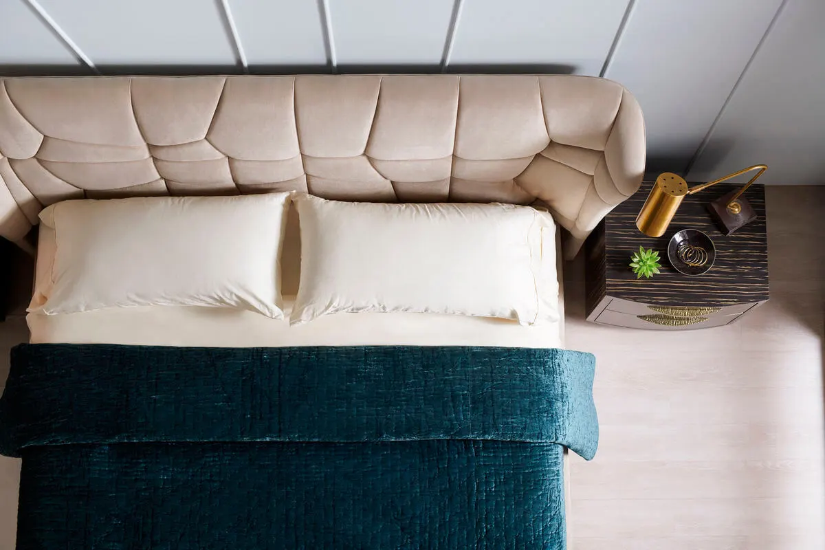top view of king cream contemporary bed with dark teal bedding
